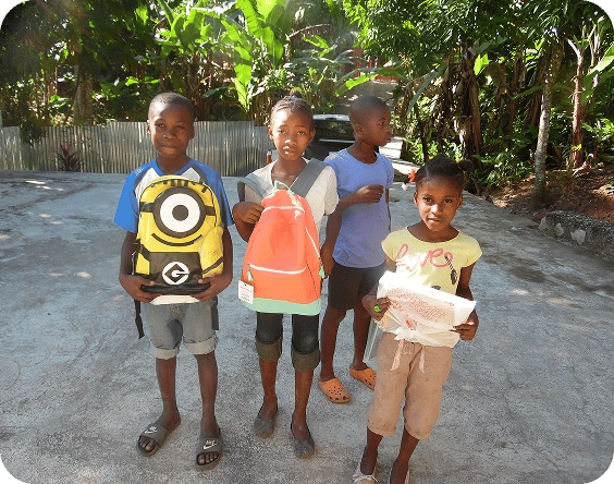Kids recieving their school supplies.