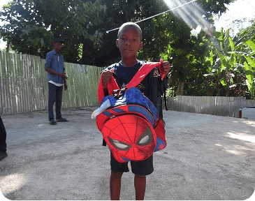 Kids recieving school supplies.
