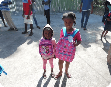 Kids recieving school supplies.