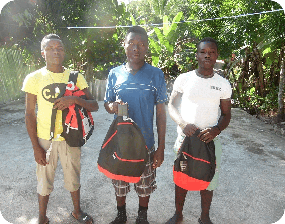 Kids showing off their school supplies.