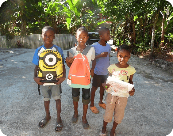 Kids showing off their school supplies.